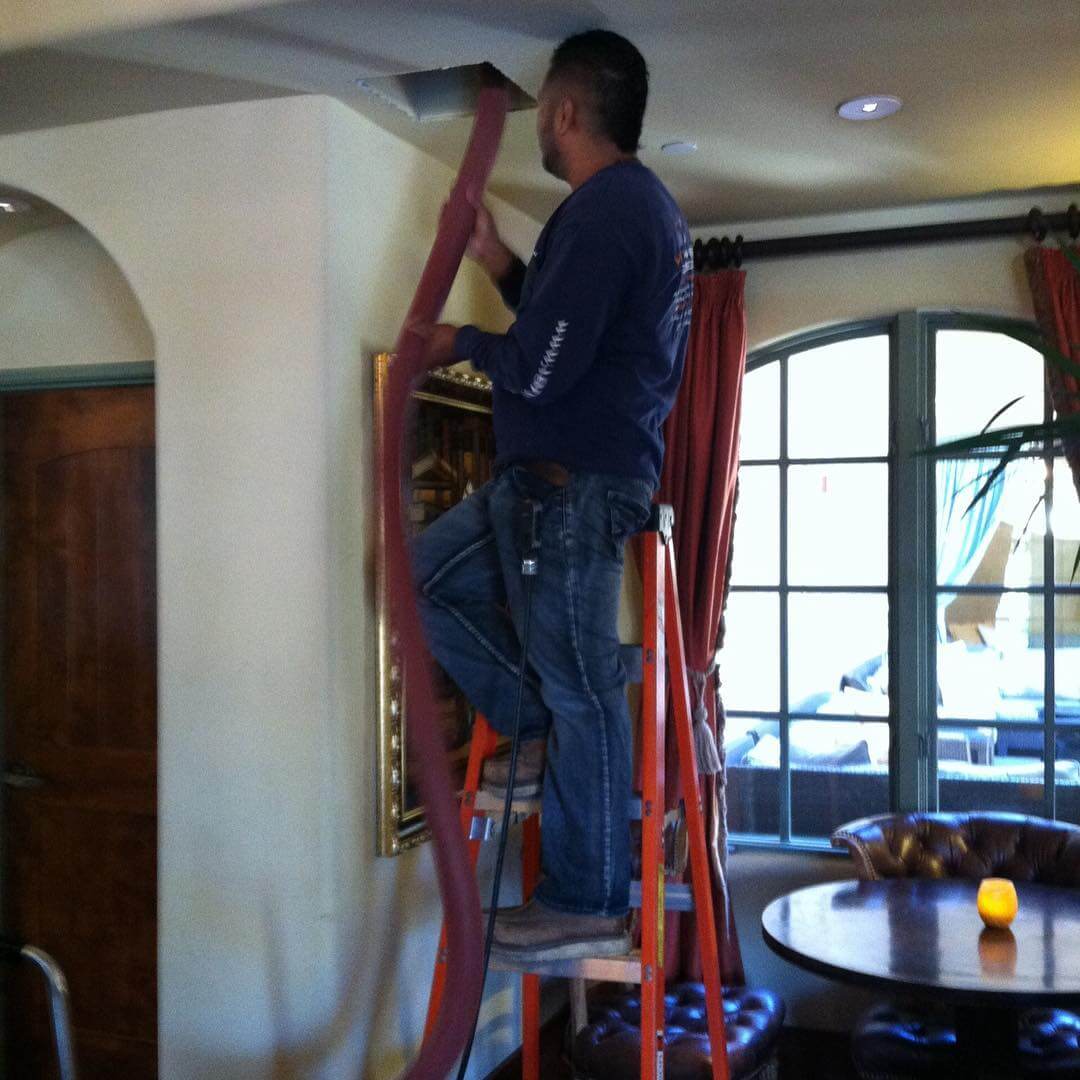 HVAC technician cleaning air ducts in San Jose home